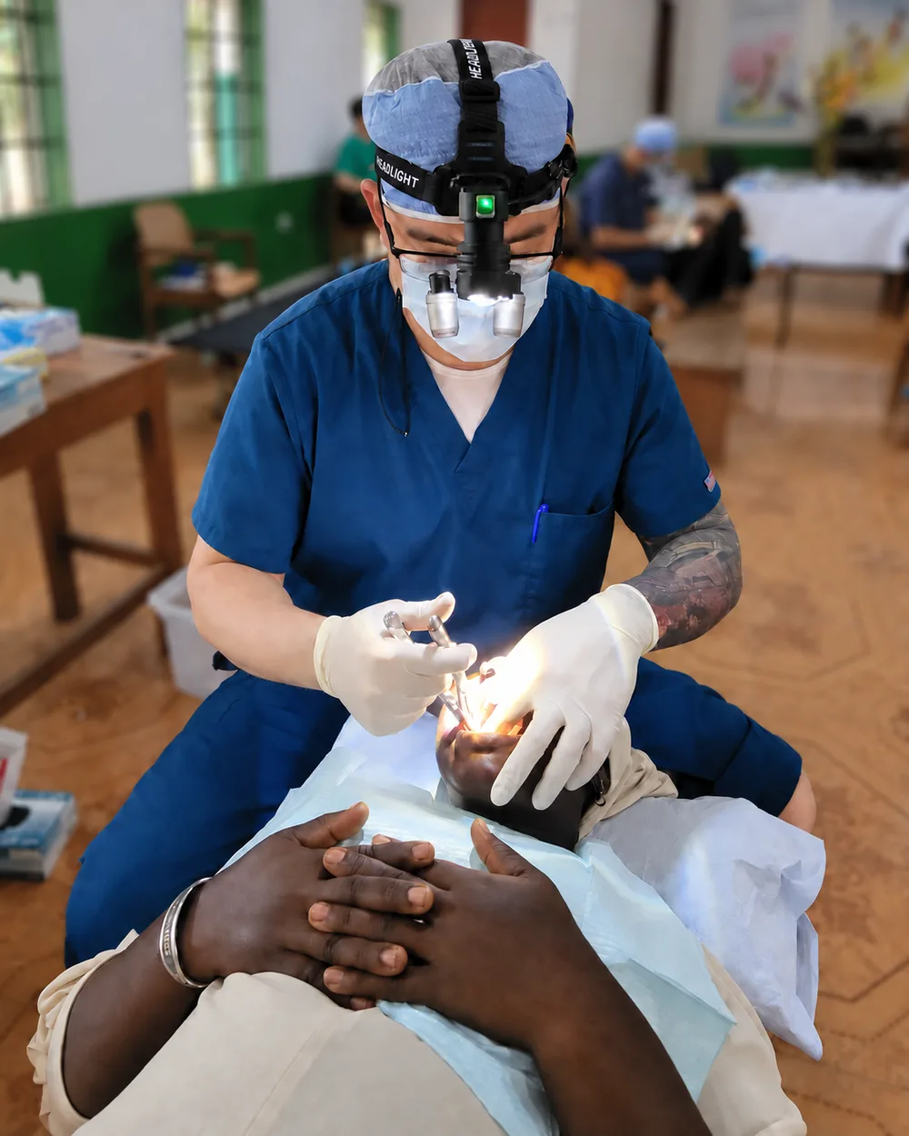 Dr. Smith providing dental care to a patient during volunteer service.
